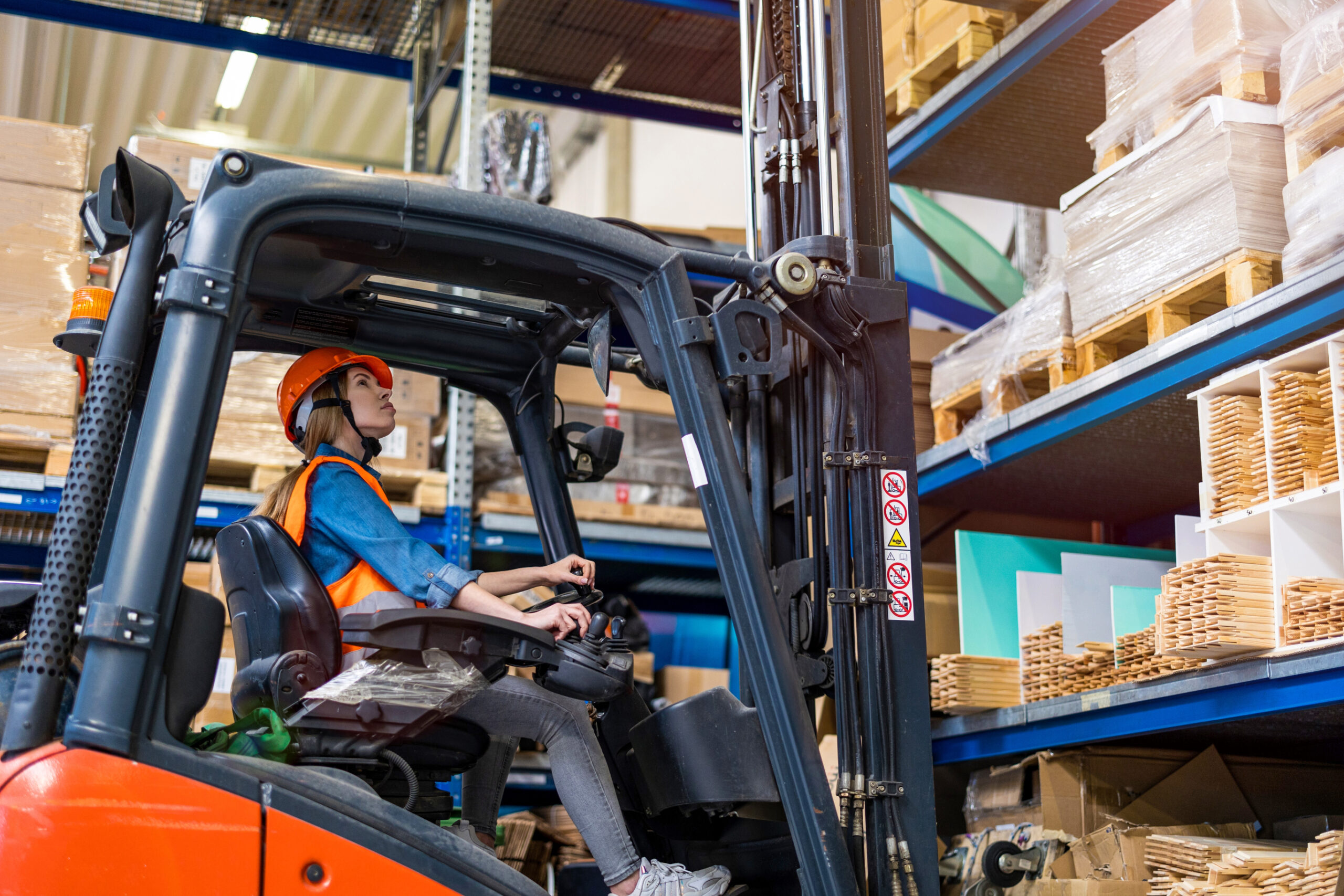 Diesel counterbalance forklift truck, loading a shelf.